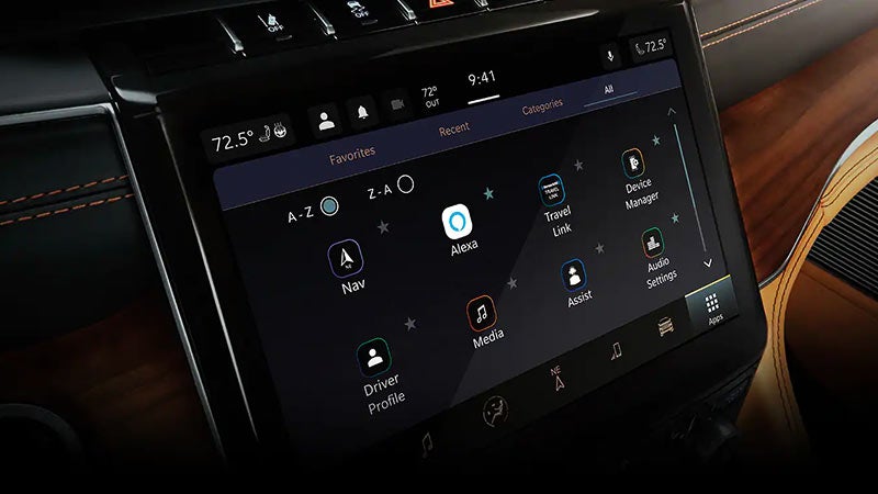 A car's infotainment screen shows the "Favorites" menu with icons for navigation, Alexa, media, and driver profiles.